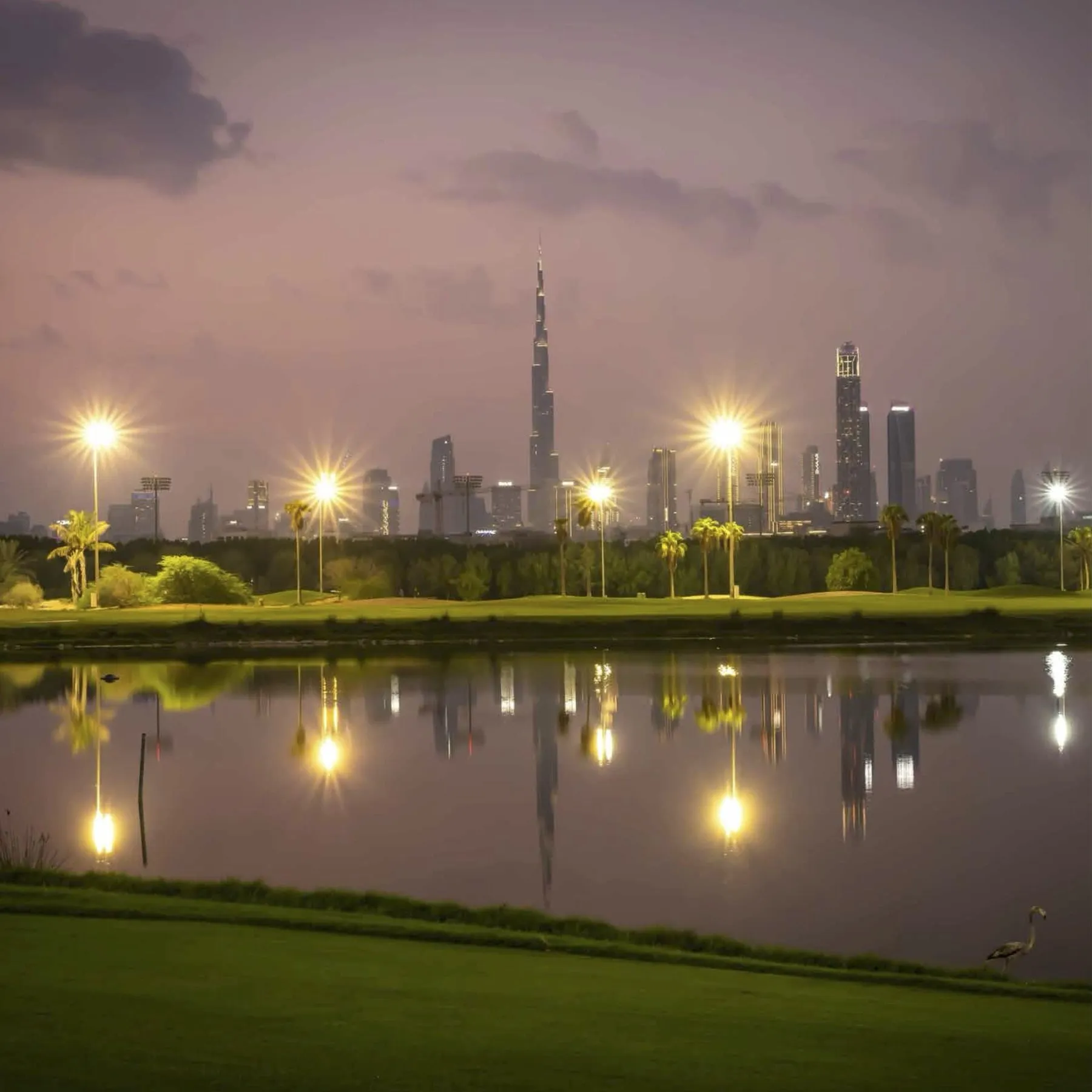 Dubai skyline at dusk seen across the Meydan golf course